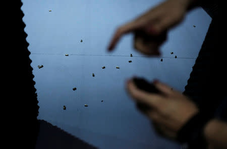 Bullets fired are seen on the floor as a woman prepares to fire a handgun at the 1911 Shooting Club in Sao Paulo, Brazil, January 11, 2019. Picture taken January 11, 2019. REUTERS/Nacho Doce