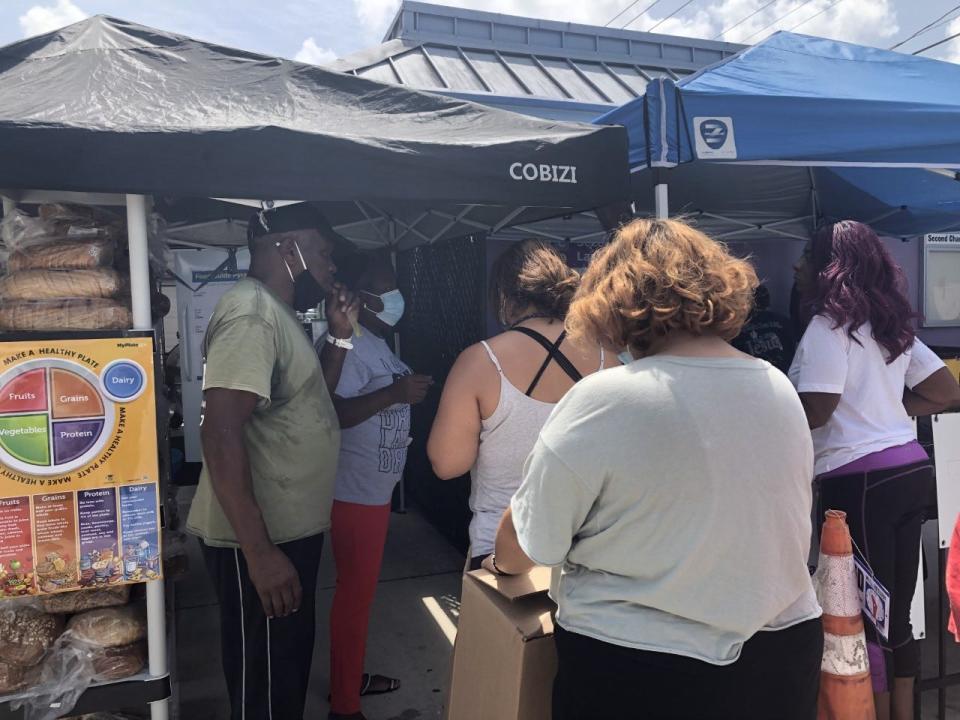 April Glasco hands out water bottles and popsicles at Second Chance Last Opportunity.