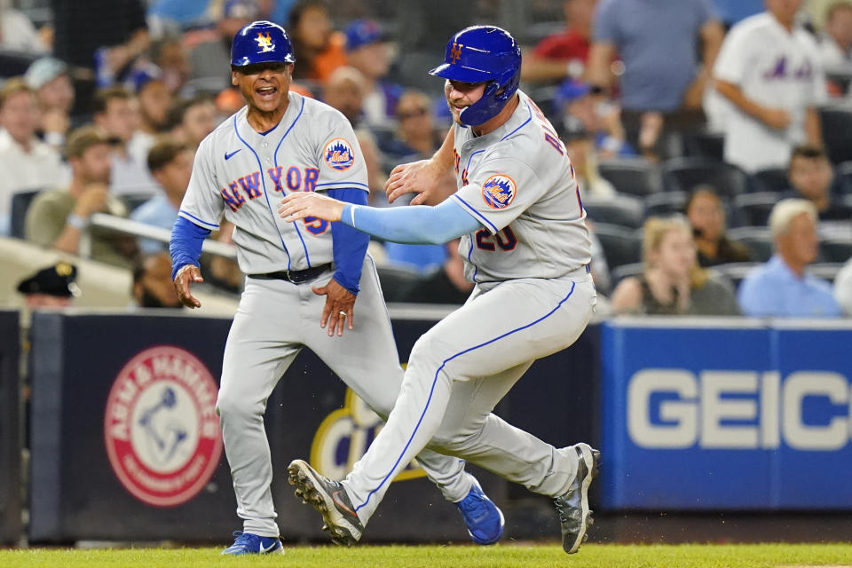 FILE - New York Mets third base coach Joey Cora, left, yells to Mets' Pete Alonso as Alonso runs to home plate to score on a Jeff McNeil double during the sixth inning of a baseball game against the New York Yankees, Tuesday, Aug. 23, 2022, in New York. The Detroit Tigers have hired four new coaches for manager A.J. Hinch's staff, adding Cora as their third base coach, the team announced Monday, Dec. 4, 2023. (AP Photo/Frank Franklin II, File)