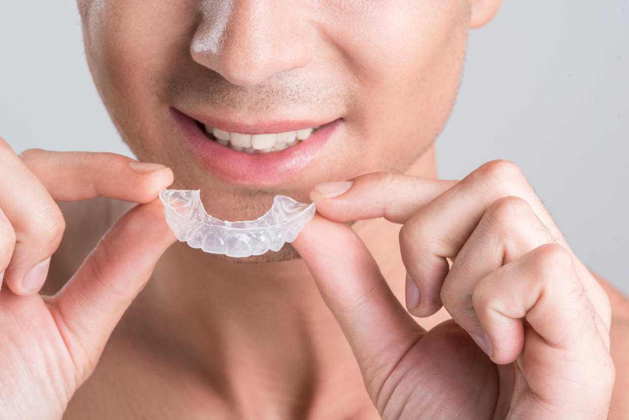 A young man with Invisalign. (Photo: Getty Images)