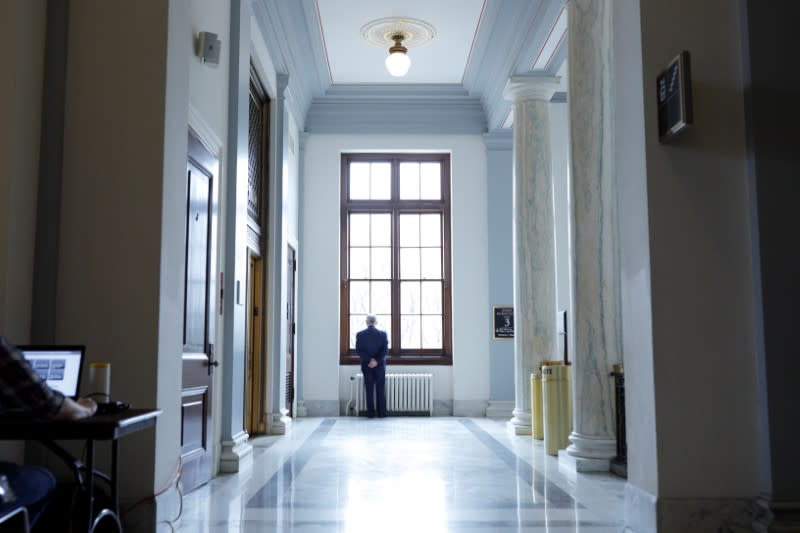 Senator Reed looks through a window between television news interviews, ahead of a vote on the coronavirus relief bill, on Capitol Hill in Washington