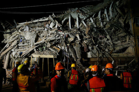 Rescuers work at a the site of a collapsed building after an earthquake in Mexico City, Mexico September 20, 2017. REUTERS/Henry Romero