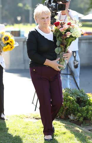 <p>Karl Larsen/BACKGRID</p> Halyna Hutchins' mother Olga at Hollywood Forever Cemetary on Oct. 21, 2023