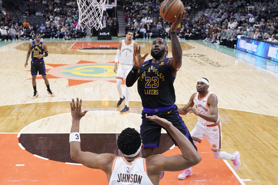 Los Angeles Lakers forward LeBron James (23) shoots over San Antonio Spurs forward Keldon Johnson (3) during the first half of an NBA basketball game in San Antonio, Friday, Dec. 15, 2023. (AP Photo/Eric Gay)