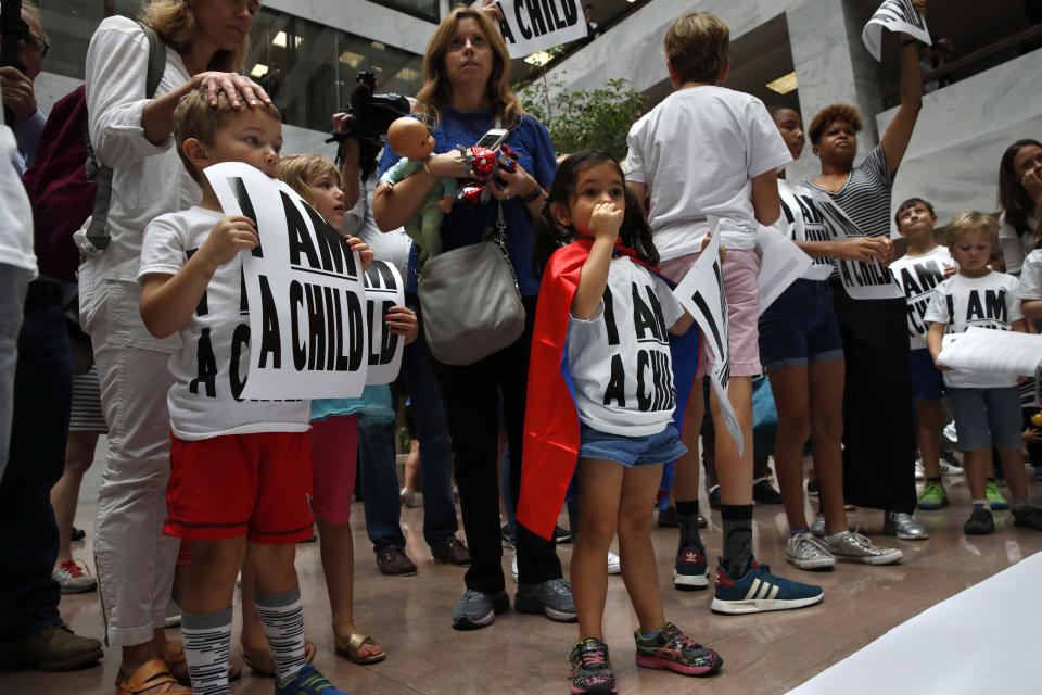 Areva Gopal, 3, of Arlington, Va., center, attends a protest of families asking for the reunification of immigrant families who were separated at the border, Thursday, July 26, 2018, on Capitol Hill in Washington. The Trump administration faces a court-imposed deadline Thursday to reunite thousands of children and parents who were forcibly separated at the U.S.-Mexico border, an enormous logistical task brought on by its "zero tolerance" policy on illegal entry. (AP Photo/Jacquelyn Martin)