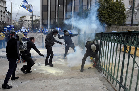 Protesters throw smoke grenades during a demonstration against the agreement reached by Greece and Macedonia to resolve a dispute over the former Yugoslav republic's name, in Athens, Greece, January 20, 2019. REUTERS/Alexandros Avramidis