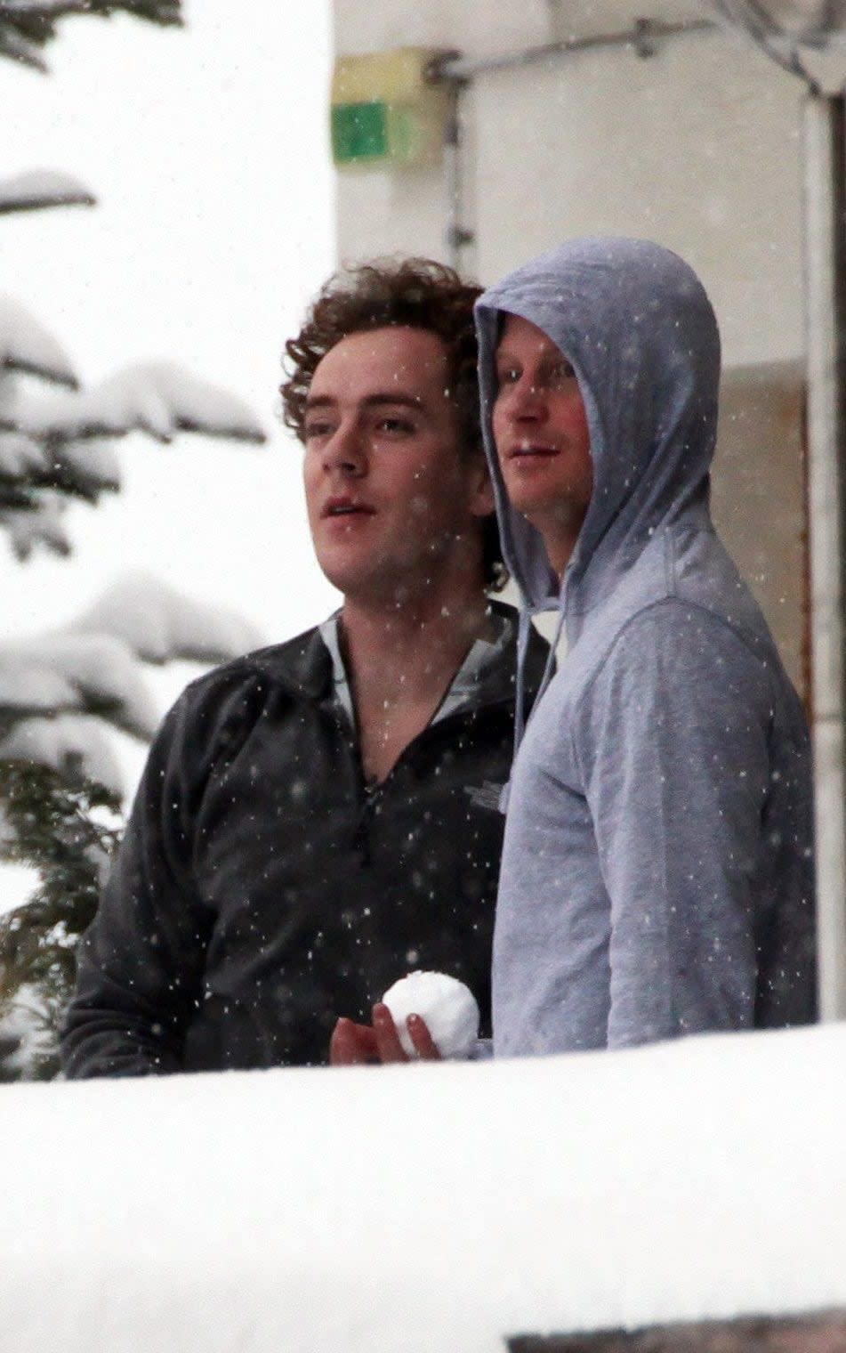 Prince Harry and his friend Tom Inskip throw snowballs from a hotel balcony at the Swiss resort of Verbier - Mark Large/ANL/Shutterstock