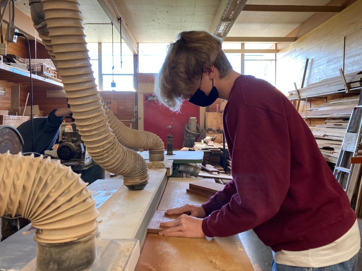 North Eugene High School Student Cormack Tobin sands down a piece of wood in an advanced woodshop class, Nov. 16, 2021.