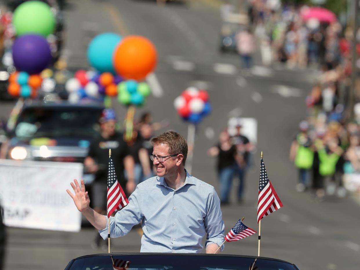 Rep. Derek Kilmer waves to the crowd along 6th street during the 76th Armed Forces Day Parade in Bremerton on May 20.