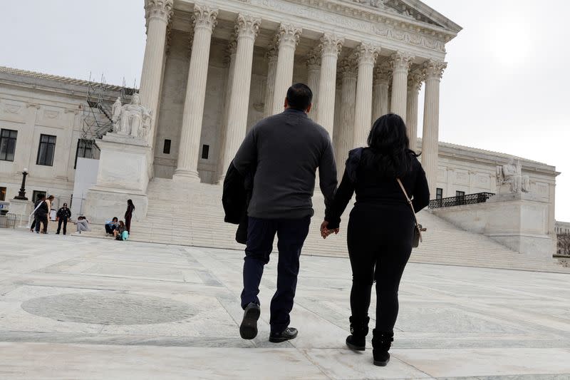 Beatrice Gonzalez and Jose Hernandez, whose child was fatally shot and killed in a 2015 rampage in Paris, are seen outside the U.S. Supreme Court in Washington