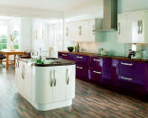 <b>Aubergine dream</b><br><br>Rounded corner-units have been popular for a while, but this high gloss kitchen from <a href="http://www.diy.com/nav/rooms/kitchens/cooke-lewis-kitchens?noCookies=false" rel="nofollow noopener" target="_blank" data-ylk="slk:Cooke & Lewis at B&Q;elm:context_link;itc:0;sec:content-canvas" class="link "><span>Cooke & Lewis at B&Q</span></a> takes streamlined elegance to a new level. <br><br>The bright aubergine base units with curved chrome handles make for a striking, contemporary kitchen. If you love strong colour but have a compact kitchen, keeping the wall cupboards white will prevent the look from becoming too overpowering.