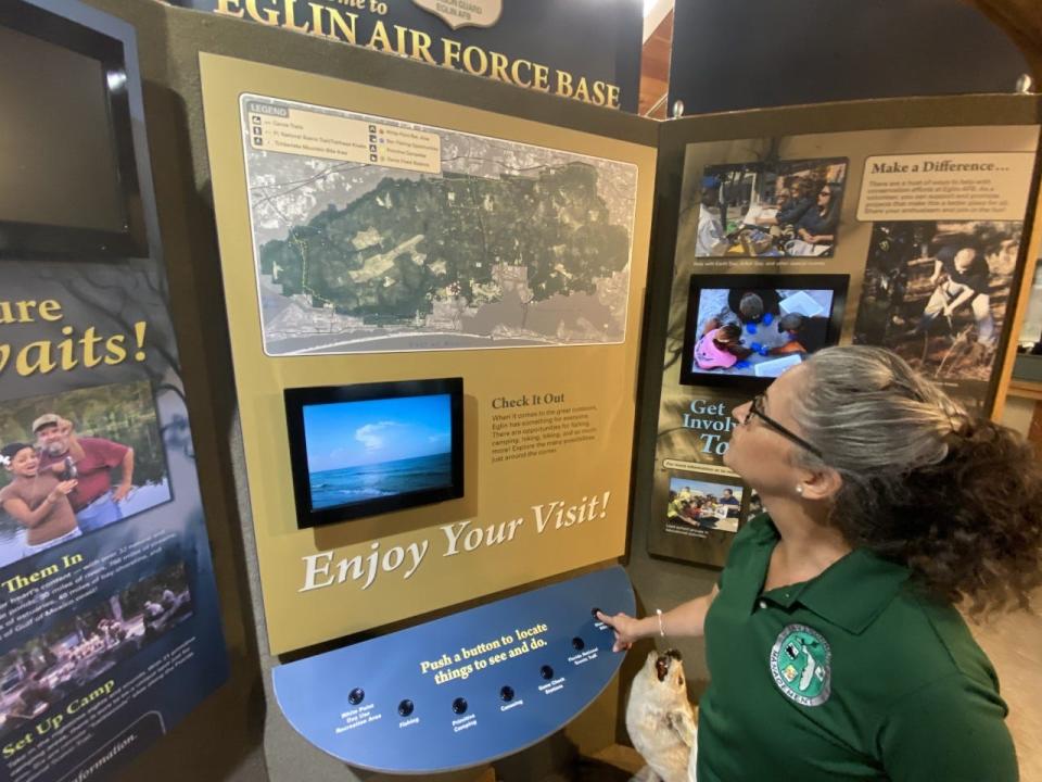 Cat Nolan, archaeology collections manager with Eglin’s Cultural Resources Office, looks at a map showing Eglin's public recreation sites. The map is in the Jackson Guard Natural Resources Office near Niceville.