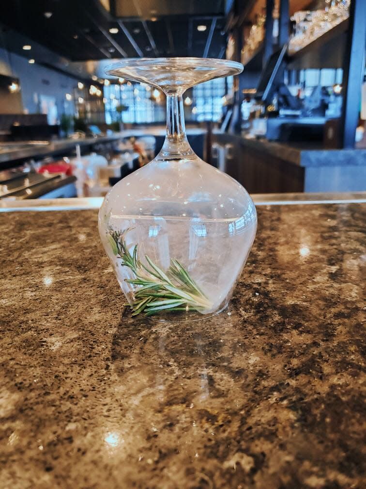 Bartenders use an upside down cocktail glass to smoke the rosemary for the Earth, Fruit & Fire mocktail at Jacksons Restaurant + Bar near the Beaver Valley Mall.