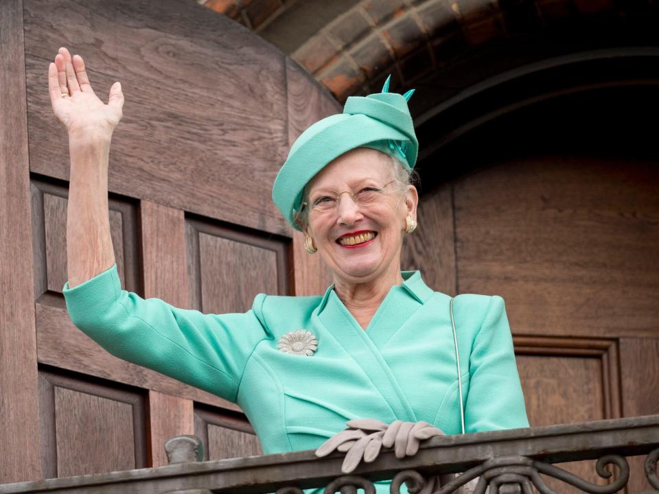 Queen Margrethe II of Denmark waves from the Town Hall balcony after lunch during festivities for her 75th birthday on April 16, 2015.