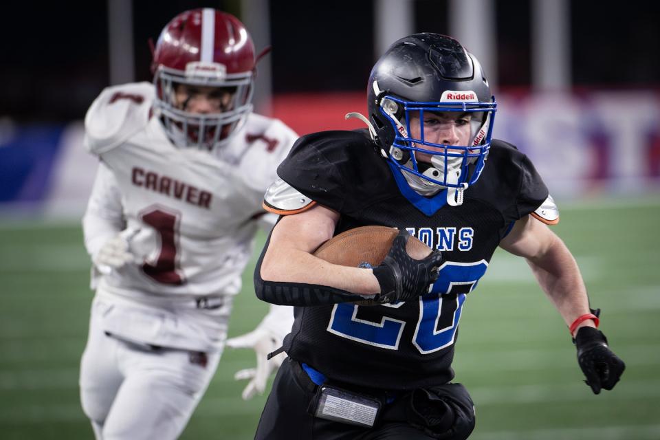 West Boylston's Connor Muldoon powers ahead of Carver's Robert Peterson for a first down during the Division 8 Super Bowl at Gillette Stadium.