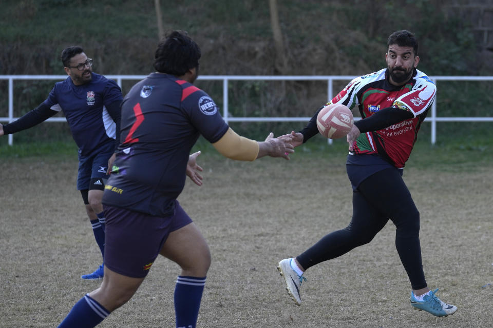 Rugby players of a local club 'Islamabad Jinns' take part in a practice session, in Islamabad, Pakistan, Saturday, Dec. 17, 2022. There is only one sport that matters in Pakistan and that's cricket, a massive money-making machine. But minors sports like rugby are struggling to get off the ground due to lack of investment and interest, stunting their growth at home and chances of success overseas. Even previously popular sports like squash and field hockey, which Pakistan dominated for decades, can't find their form. (AP Photo/Anjum Naveed)