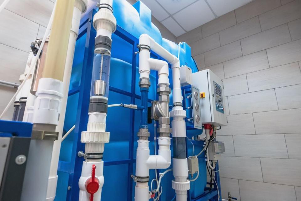 A close up of a whole house reverse osmosis system.