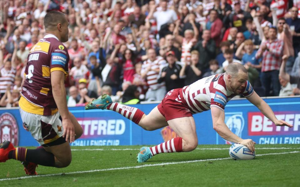 Liam Marshall dives over the whitewash to allow Wigan to get hands on 20th Challenge Cup trophy - SHUTTERSTOCK