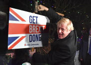Britain's Prime Minister and Conservative party leader Boris Johnson poses as he hammers a "Get Brexit Done" sign into the garden of a supporter, in Benfleet, east of London on Wednesday, Dec. 11, 2019, the final day of campaigning for the general election. Britain goes to the polls on Thursday. (Ben Stansall/Pool Photo via AP)