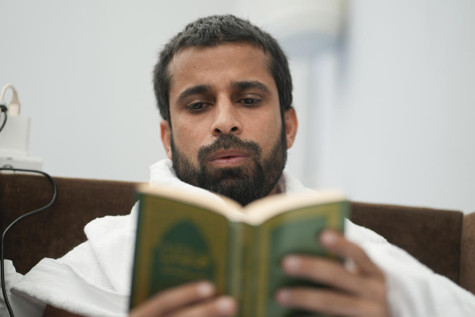 A Muslim pilgrim reads the Quran, the Muslims holy book, at the Mina tent camp, in Mecca, Saudi Arabia, during the annual hajj pilgrimage, Monday, June 26, 2023. Muslim pilgrims are converging on Saudi Arabia's holy city of Mecca for the largest hajj since the coronavirus pandemic severely curtailed access to one of Islam's five pillars. (AP Photo/Amr Nabil)