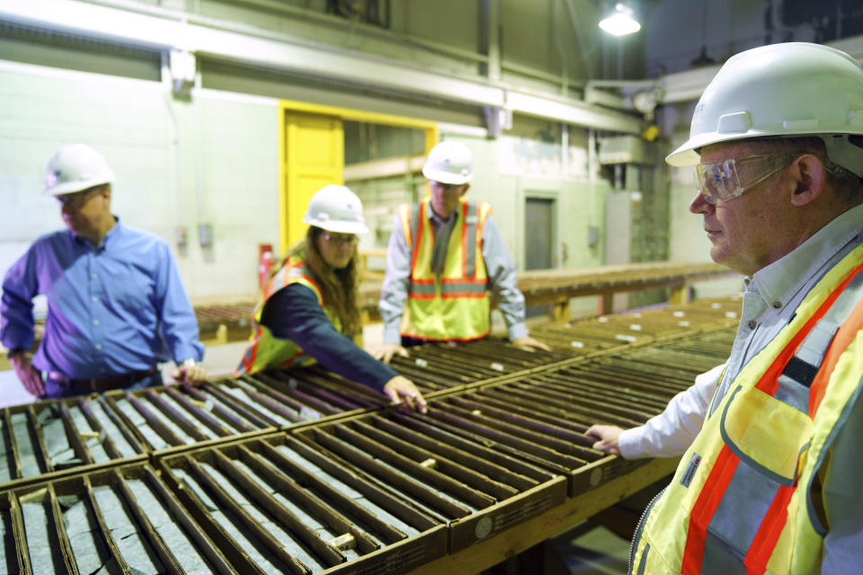 In this Wednesday, May 29, 2019 photo, Jon Cherry, left, President, CEO and Director at Polymet, Bruce Richardson, Vice President of Corporate Communications and External Affairs, and LaTisha Gietzen, center, Vice-President of Public, Government, and Environmental Affairs, tour the site of the Polymet copper-nickel mine to discuss what's next now that the controversial project has it's major environmental permits in Hoyt Lakes, Minn. (Anthony Souffle/Star Tribune via AP)