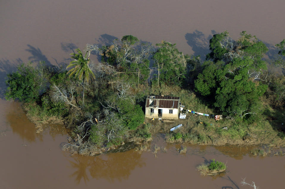 A house surrounded by flood water near Beira, Mozambique, Thursday, March 28, 2019. The first cases of cholera have been confirmed in the cyclone-ravaged city of Beira, Mozambican authorities announced on Wednesday, raising the stakes in an already desperate fight to help hundreds of thousands of people sheltering in increasingly squalid conditions. (AP Photo/Themba Hadebe)