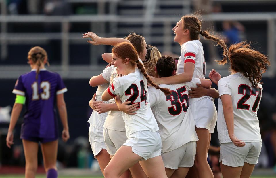 Manchester girls soccer players celebrate defeating Champion in a Division III regional final Saturday in Tallmadge.