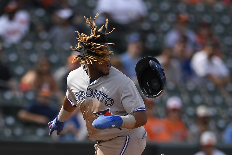 Toronto Blue Jays' Vladimir Guerrero Jr. loses his helmet as he runs to third on a single by Randal Grichuk during the ninth inning of a baseball game against the Baltimore Orioles, Sunday, Aug. 4, 2019, in Baltimore. (AP Photo/Nick Wass)