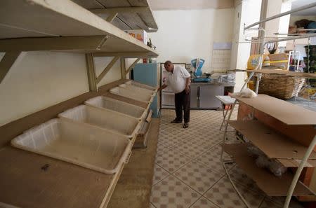 Adao Pereira, 54, owner of a grocery store which is located near the dam at Brazilian miner Vale's Gongo Soco mine, is seen next to empty shelves amid reports that the dam may soon collapse, in Barao de Cocais, Minas Gerais state, Brazil May 24, 2019. REUTERS/Washington Alves