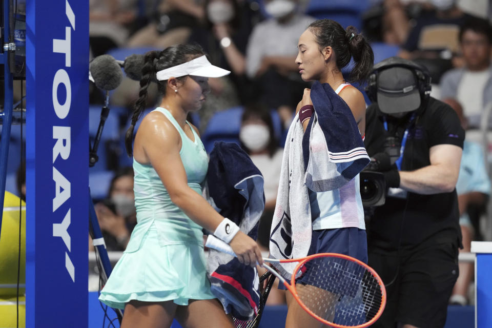 Zheng Qinwen, right, of China and Claire Liu, left, of the U.S. walk to play during a singles quarterfinal match in the Pan Pacific Open tennis tournament at Ariake Colosseum Friday, Sept. 23, 2022, in Tokyo. (AP Photo/Eugene Hoshiko)