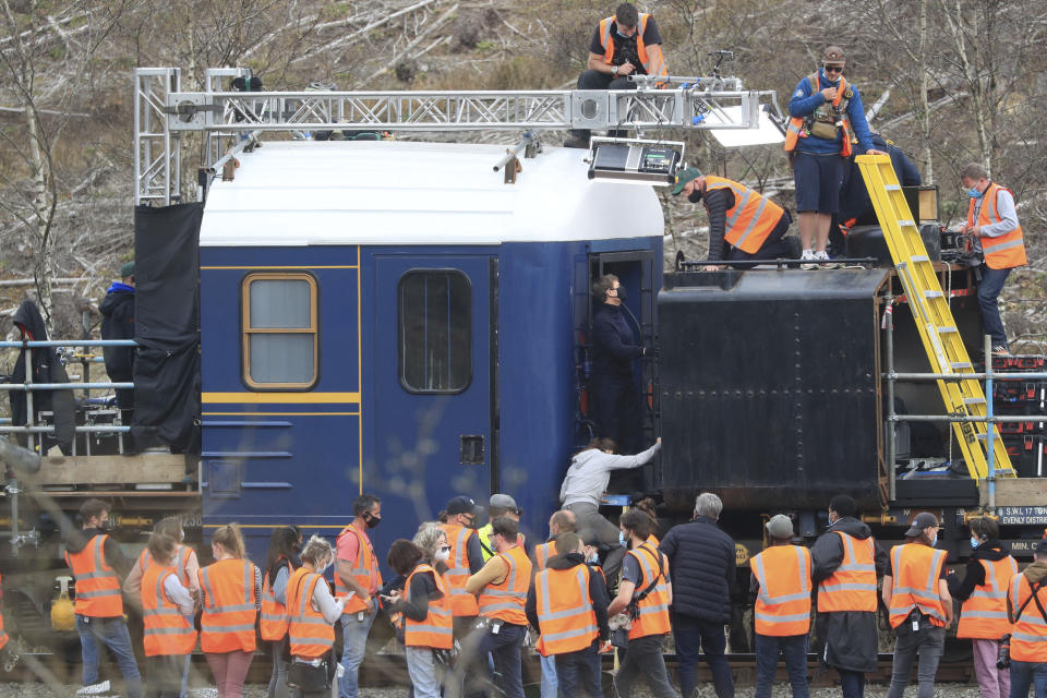 Actor Tom Cruise, center, on the set of his latest project, which is filming in the sidings of the railway station in the village of Levisham in the North York Moors, England, Tuesday, April 20, 2021. (Danny Lawson/PA via AP)