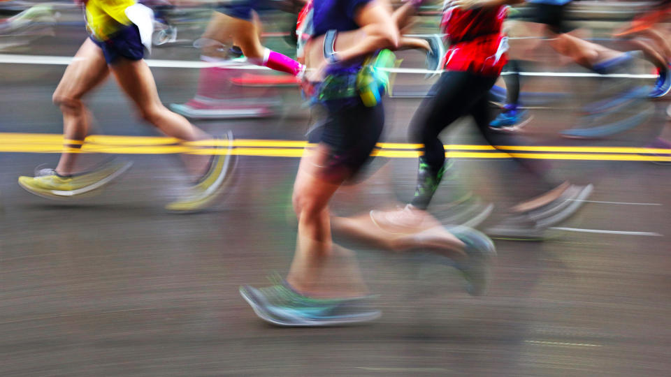 Blurred Action Of Marathon Runners On City Street