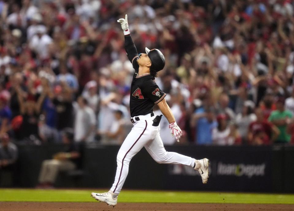 Arizona Diamondbacks outfielder Alek Thomas (5) hits a game-tying 2-run home run against the Philadelphia Phillies during Game 4 of the NLCS at Chase Field in Phoenix on Oct. 20, 2023.