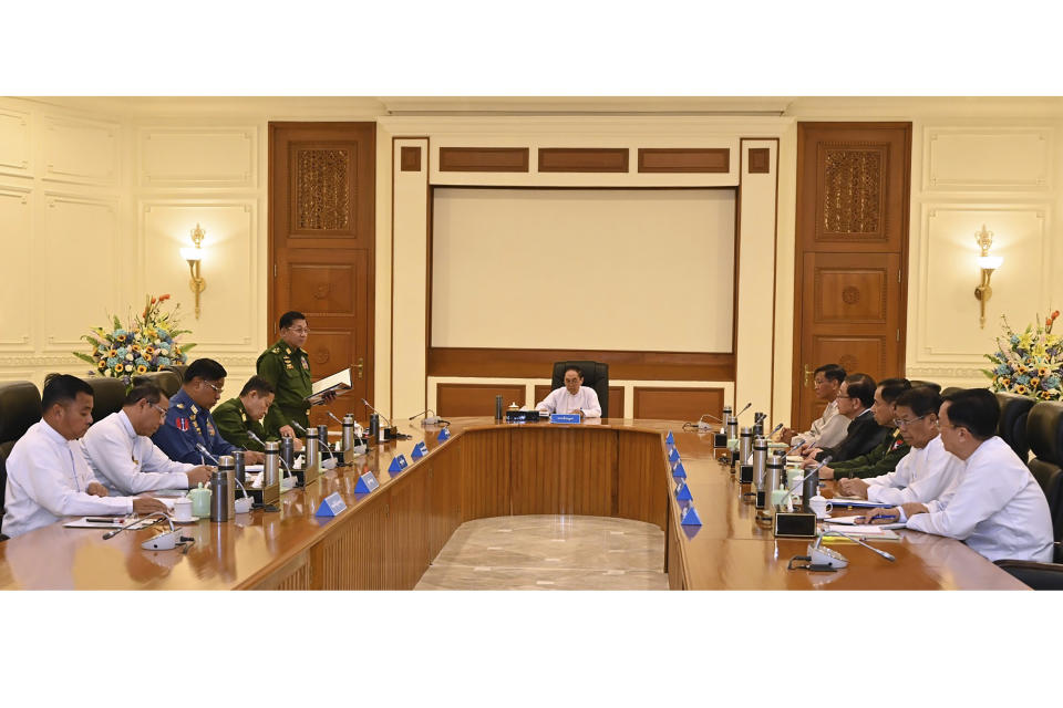 FILE - In this photo from The Military True News Information Team on Jan. 31, 2023, Senior Gen. Min Aung Hlaing, center left, chairman of State Administration Council, speaks with members the National Defense and Security Council including Myint Swe, center, Acting President of the military government, and Vice President Henry Van Thio, center right, in Naypyitaw, Myanmar. (The Military True News Information Team via AP, File)