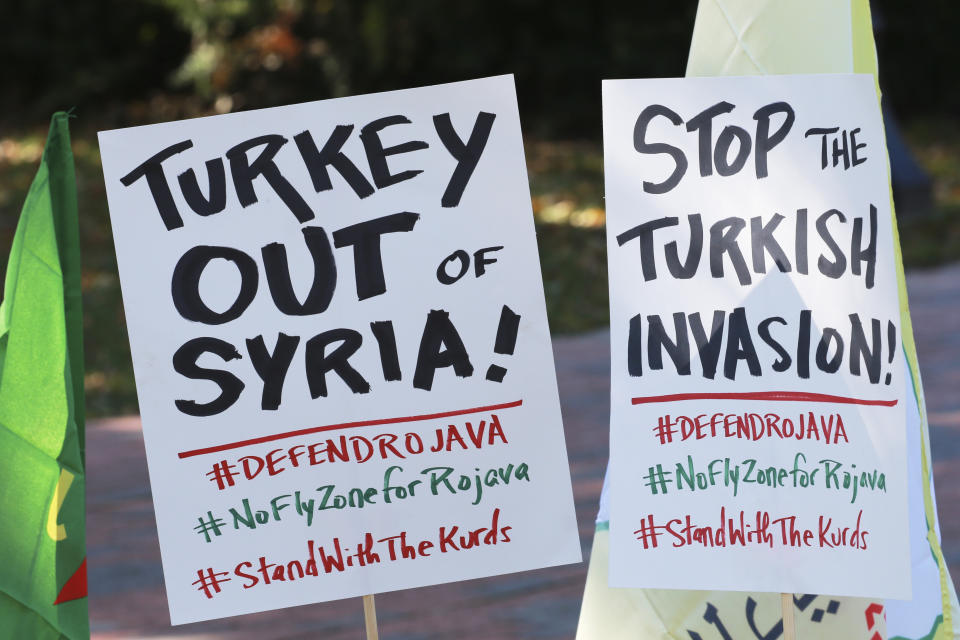 A small group of protesters post signs as they prepare for a rally against Turkish President Recep Tayyip Erdogan at Lafayette Square in front of the White House in Wednesday, Nov. 13, 2019, in Washington. Erdogan is meeting with President Donald Trump. (AP Photo/Steve Helber)