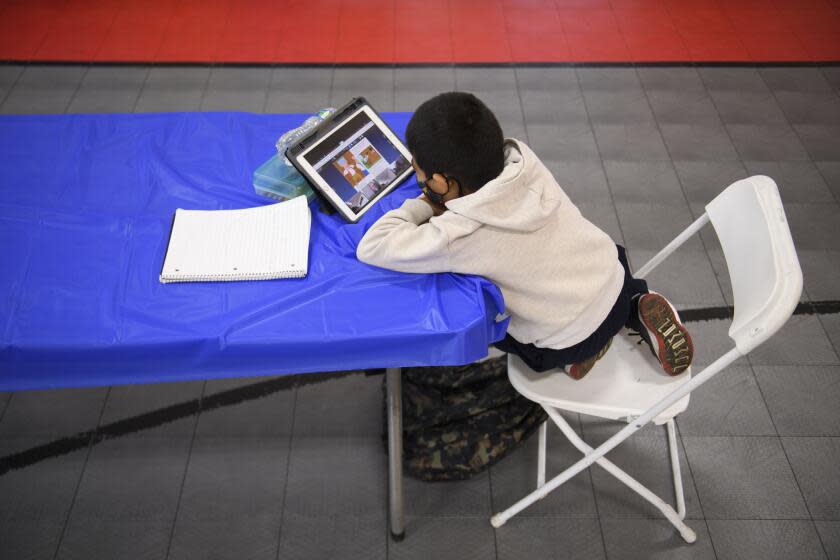A child attends an online class at a learning hub inside the Crenshaw Family YMCA during the Covid-19 pandemic on February 17, 2021 in Los Angeles, California. - While many area schools remain closed for in-person classes, the learning hub program provides structured distance education resources including free WiFi, electricity, staff support, academic tutoring, and recreation activities to provide a safe environment to support low income and minority communities. (Photo by Patrick T. FALLON / AFP) (Photo by PATRICK T. FALLON/AFP via Getty Images)
