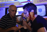 <p>A Juventus’ fan walks injured as the fans gathered in San Carlo Square run away following panic created by the explosion of firecrackers as they was watching the match on a giant screen on June 3, 2017. (Giorgio Perottino/Reuters) </p>