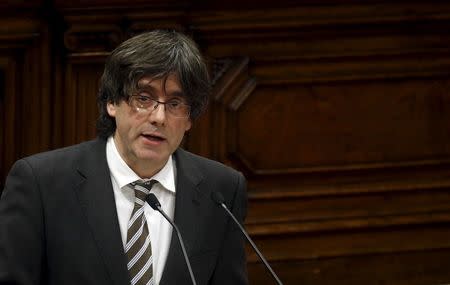 Incoming Catalan President Carles Puigdemont delivers a speech during the investiture session at the Catalunya Parliament in Barcelona, Spain, January 10, 2016. REUTERS/Albert Gea