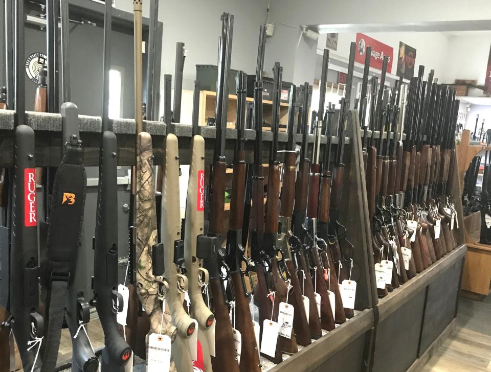 Dozens of rifles, shotguns and other firearms are on display at Scott's Guns & Accessories in Horseheads. Under a new state law, all buyers of firearms and ammunition have to undergo a state police background check.