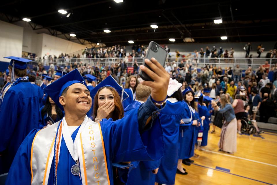 Carlos Sanchez Chavez and Brianna Ramirez Chavez take a selfie during the McNary High School graduation ceremony at McNary High School in Keizer, Oregon on Friday, June 10, 2022.