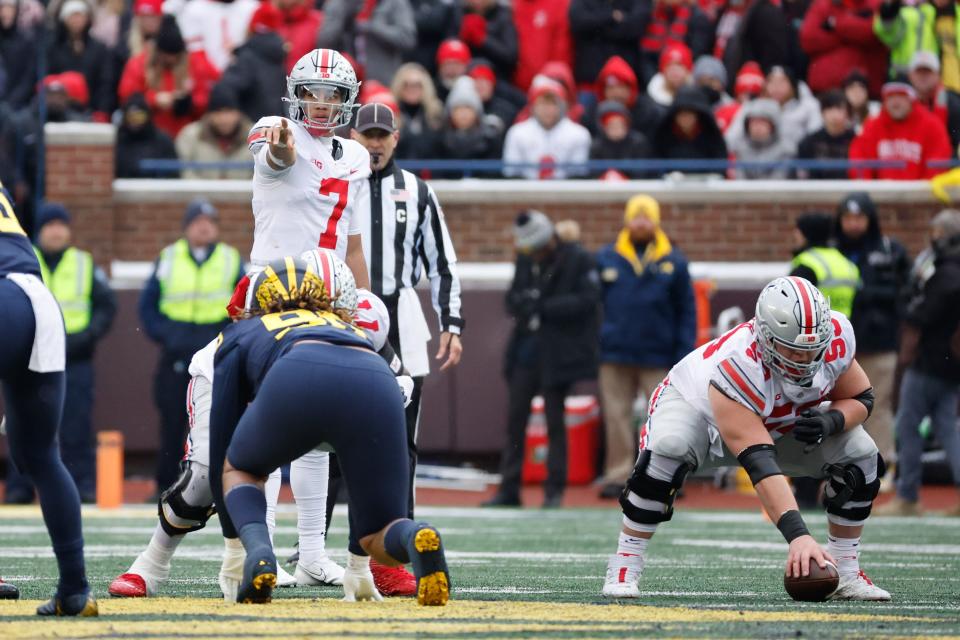 Ohio State quarterback C.J. Stroud (7) gets set to run a play during his team's 2021 game against Michigan at Michigan Stadium.