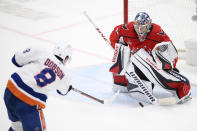 Washington Capitals goaltender Darcy Kuemper stops a shot by New York Islanders defenseman Noah Dobson (8) during overtime of an NHL hockey game, Wednesday, March 29, 2023, in Washington. The Islanders won 2-1 in a shootout. (AP Photo/Nick Wass)