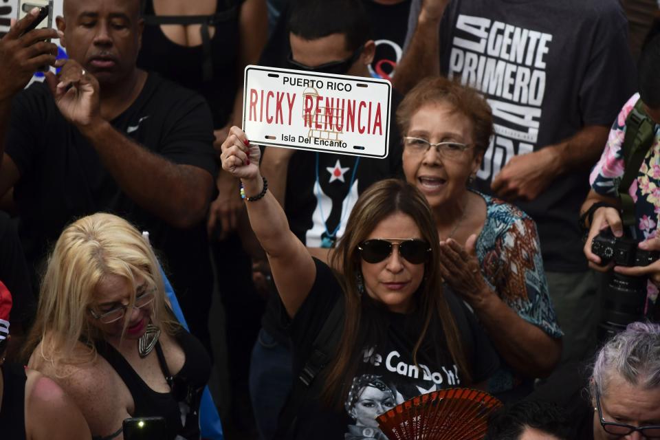 Dozens of citizens, most of them from several workers unions, carry out a protest against governor Ricardo Rossello, in San Juan, Puerto Rico, Friday, July 19, 2019. Protesters are demanding Rossello step down for his involvement in a private chat in which he used profanities to describe an ex-New York City councilwoman and a federal control board overseeing the island's finance. (AP Photo/Carlos Giusti)