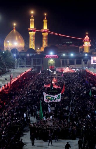 Shiite Muslims gather outside the shrine of Imam Abbas in Karbala early on Sunday. 30,000 security forces personnel have been deployed at the northern, southern and eastern entrances of Karbala to protect the pilgrims