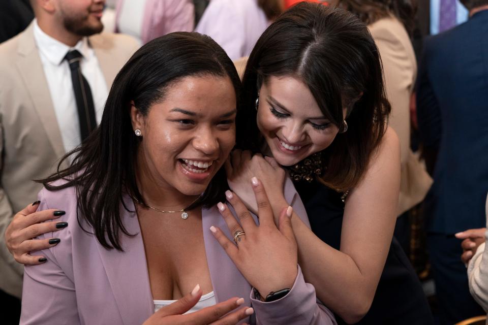 Selena Gomez hugs youth mental health leader Ayanna Kelly at the White House in Washington, as first lady Jill Biden speaks during the White House Conversation on Youth Mental Health.