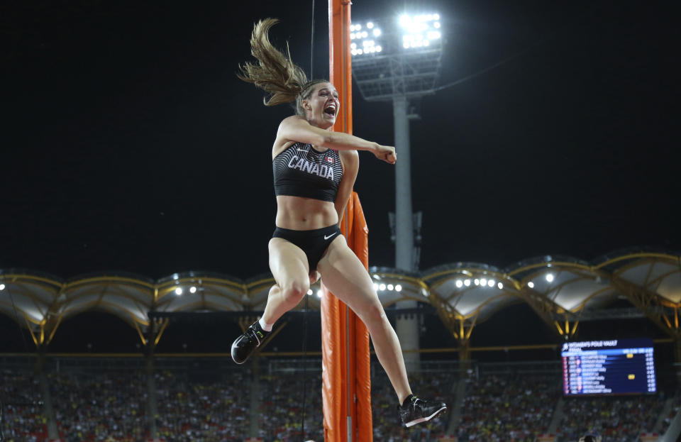 FILE - In this April 13, 2018, file photo, Gold medal winner Canada's Alysha Newman celebrates after her performance in the woman's pole vault final at Carrara Stadium during the Commonwealth Games on the Gold Coast, Australia. Three of the leading women’s pole vaulters will take their turn to compete in the second edition of the Ultimate Garden Clash. Katerina Stefanidi of Greece, Katie Nageotte of the United States and Alysha Newman of Canada will participate in the event but won’t be competing in their backyards since they don’t have the equipment at home. They will instead be at nearby training facilities. (AP Photo/Dita Alangkara, File)