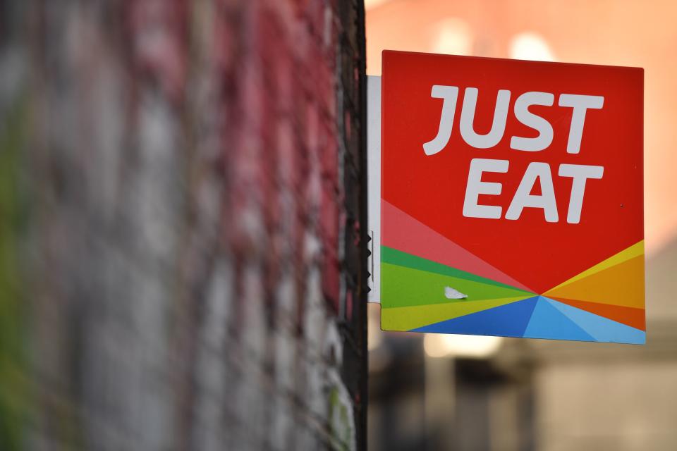 A sign for Just Eat, a food delivery service can be seen above a restaurant in London on December 18, 2017. Photo: BEN STANSALL/AFP/Getty Images