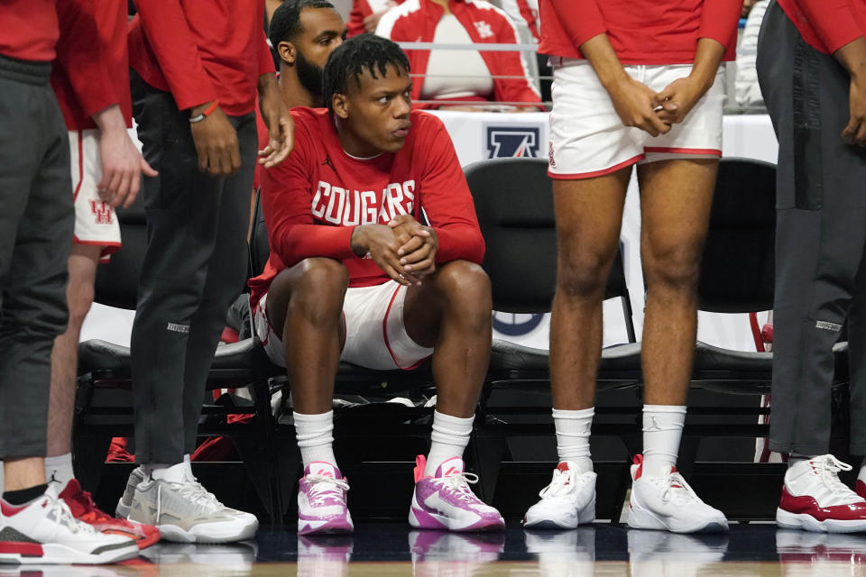 Houston's Marcus Sasser sits on the bench during the first half of an NCAA college basketball game against Memphis in the finals of the American Athletic Conference Tournament, Sunday, March 12, 2023, in Fort Worth, Texas. (AP Photo/LM Otero)