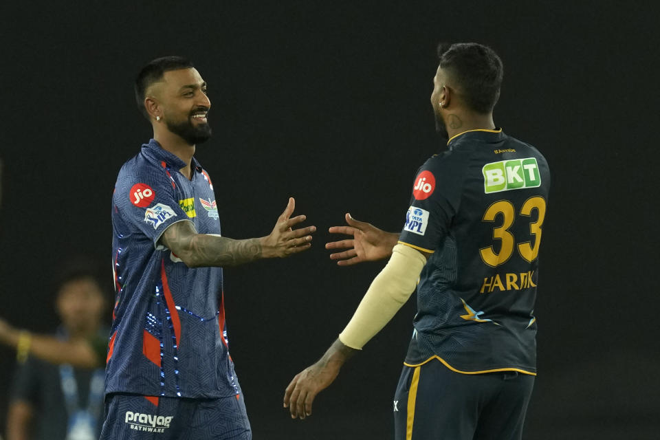 Lucknow Super Giants' captain Krunal Pandya, left, walks to congratulate Gujarat Titans' captain Hardik Pandya on their win in the Indian Premier League cricket match between Gujarat Titans and Lucknow Super Giants in Ahmedabad, India, Wednesday, May 7, 2023. (AP Photo/Ajit Solanki)