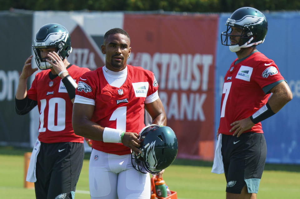 Philadelphia Eagles quarterback Jalen Hurts, center, looks on with quarterback Nick Mullens, left, and quarterback Joe Flacco, right, during practice at NFL football training camp, Wednesday, July 28, 2021, in Philadelphia. (AP Photo/Chris Szagola)